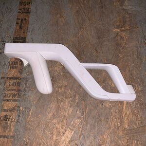 Shooting controller holder with nunchuck and Wii remote included.